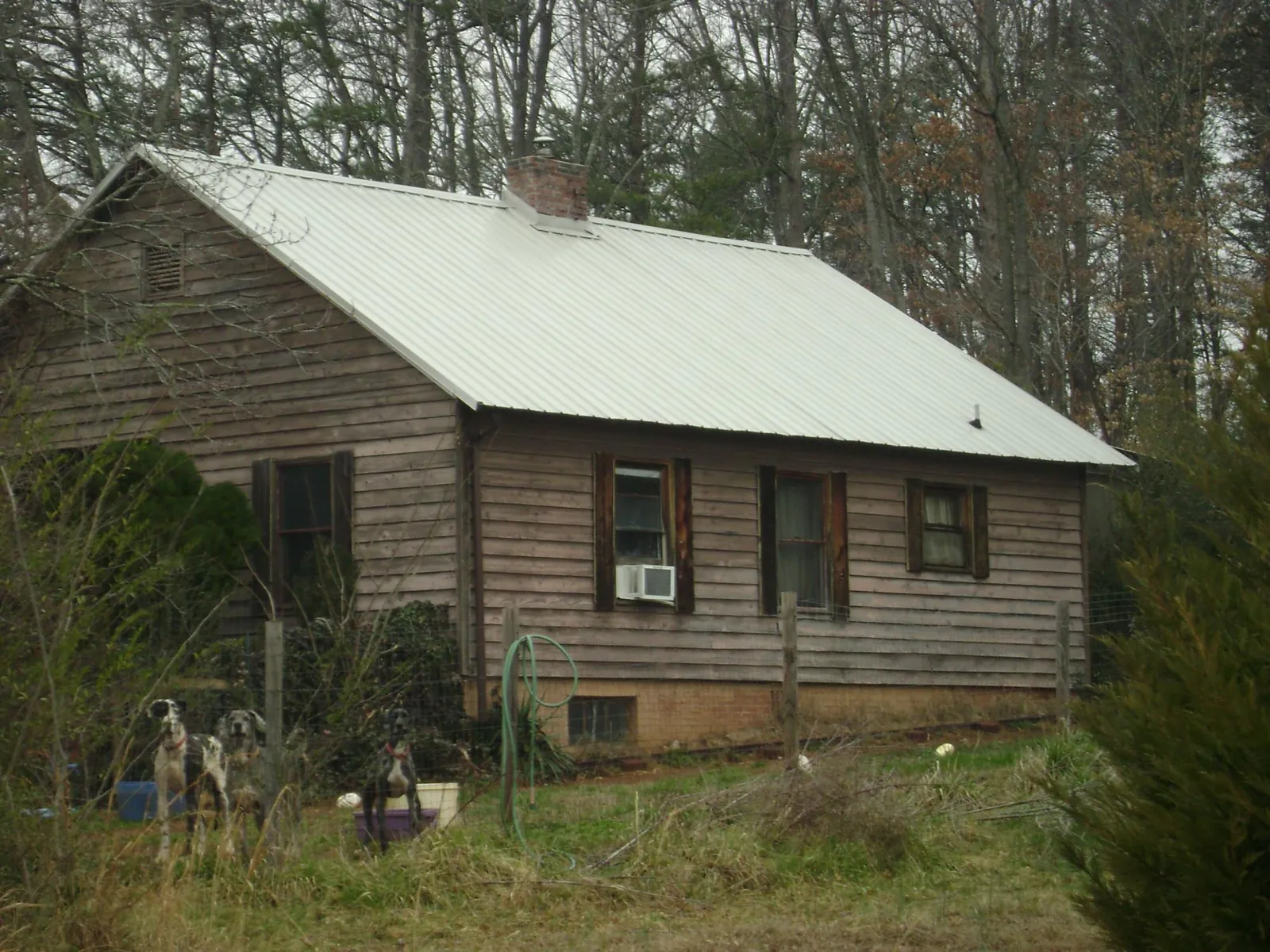 White metal roof on an old wood sided farmhouse, from a Asphalt Shingle Roof Repair job in Mannsville